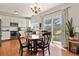 Bright dining area features wood floors, access to kitchen and sliding glass doors to the outdoor space at 3912 Miners Candle Pl, Castle Rock, CO 80109