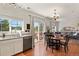 Bright dining area features wood floors, a chandelier and sliding glass doors to the outdoor patio at 3912 Miners Candle Pl, Castle Rock, CO 80109