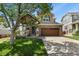 Charming two-story home showcasing a well-maintained front yard, inviting porch, and a brick two-car garage at 3912 Miners Candle Pl, Castle Rock, CO 80109