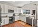 Bright kitchen with sleek stainless steel appliances, white cabinetry and natural light streaming through the window at 3912 Miners Candle Pl, Castle Rock, CO 80109
