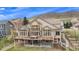 An eye-catching home featuring a large deck and expansive windows to capture the mountain views at 11065 W Rockland Dr, Littleton, CO 80127