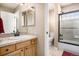 Bathroom vanity with sink, mirror, and shower over tub, offering a functional space at 11065 W Rockland Dr, Littleton, CO 80127