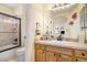 Bathroom featuring a shower over tub, vanity with sink, and neutral tiling at 11065 W Rockland Dr, Littleton, CO 80127