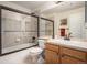 Bathroom with a shower over tub, a single sink vanity, and a large mirror at 11065 W Rockland Dr, Littleton, CO 80127
