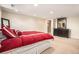 Bedroom with large bed, carpet flooring, and a wooden dresser at 11065 W Rockland Dr, Littleton, CO 80127