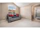 Bedroom with a large window, and an ensuite bathroom featuring a shower over tub at 11065 W Rockland Dr, Littleton, CO 80127