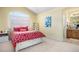 Bright bedroom with vaulted ceiling, large window, and ensuite bathroom access at 11065 W Rockland Dr, Littleton, CO 80127