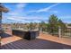 Wooden deck with wrought iron railing and outdoor seating overlooking the backyard at 11065 W Rockland Dr, Littleton, CO 80127