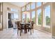 Charming dining area with abundant natural light, tile flooring, and sliding door access to the outdoor space at 11065 W Rockland Dr, Littleton, CO 80127