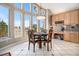 Bright dining area with large windows, tile flooring, and a stylish chandelier, perfect for Gathering meals at 11065 W Rockland Dr, Littleton, CO 80127