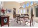Bright dining room featuring a large window and elegant chandelier, ideal for hosting gatherings at 11065 W Rockland Dr, Littleton, CO 80127