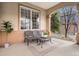 Inviting covered porch furnished with seating, creating a cozy and welcoming entrance to the home at 11065 W Rockland Dr, Littleton, CO 80127