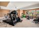 Home gym with various exercise machines and equipment, including free weights at 11065 W Rockland Dr, Littleton, CO 80127