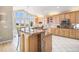 Gourmet kitchen with custom cabinetry, granite countertops, stainless steel appliances, and great natural light at 11065 W Rockland Dr, Littleton, CO 80127