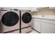 Laundry room with modern washer and dryer, and ample counter space at 11065 W Rockland Dr, Littleton, CO 80127