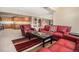 Comfortable living room with a coffee table featuring a chess board and red leather furnishings at 11065 W Rockland Dr, Littleton, CO 80127