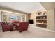 Spacious living room with large windows, built-in shelving, and comfortable seating area at 11065 W Rockland Dr, Littleton, CO 80127