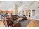 Spacious living room featuring hardwood floors, comfortable seating, and access to a modern kitchen and second-story landing at 11065 W Rockland Dr, Littleton, CO 80127