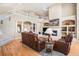 Elegant living room with a soaring ceiling, hardwood floors, fireplace, and an open view of the second story at 11065 W Rockland Dr, Littleton, CO 80127