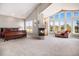 Sun-filled bedroom with a fireplace and large windows offering scenic views at 11065 W Rockland Dr, Littleton, CO 80127