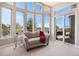Inviting sun room with ample windows and a sliding door to the balcony at 11065 W Rockland Dr, Littleton, CO 80127