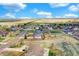 Aerial neighborhood view featuring neatly arranged houses and expansive open fields at 16680 Stroilway St, Hudson, CO 80642