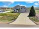 Expansive view of a lovely two-story home showcasing a long driveway and well-maintained lawn at 16680 Stroilway St, Hudson, CO 80642