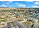 Wide aerial shot displaying neighborhood layout with green spaces and clear roads at 16680 Stroilway St, Hudson, CO 80642