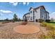 Beautiful backyard featuring a stone patio, outdoor seating, and well-maintained landscaping at 16680 Stroilway St, Hudson, CO 80642