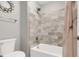 Modern bathroom with stylish shower and tiled walls, creating a refreshing space at 16680 Stroilway St, Hudson, CO 80642