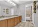 Bathroom featuring a double vanity with granite countertops and a tiled shower/tub at 16680 Stroilway St, Hudson, CO 80642