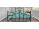 Bedroom with a black metal bed frame and bright blue comforter on a plush carpet at 16680 Stroilway St, Hudson, CO 80642