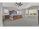 Expansive bedroom with vaulted ceilings, multiple windows, a ceiling fan, and a large wood bed at 16680 Stroilway St, Hudson, CO 80642