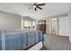 The large bedroom has a vaulted ceiling, ceiling fan, dresser, and a comfortable king-sized bed with blue bedding at 16680 Stroilway St, Hudson, CO 80642
