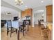 Bright dining area features wood floors, a table for four, and seamless access to the kitchen, living room, and breakfast nook at 16680 Stroilway St, Hudson, CO 80642
