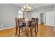 Traditional dining room with a dark wood table and chairs under a decorative chandelier lighting up the space at 16680 Stroilway St, Hudson, CO 80642