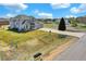 Inviting home exterior with well-manicured lawn and a long driveway at 16680 Stroilway St, Hudson, CO 80642