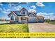 Charming two-story home with a three-car garage, inviting porch, and beautifully maintained lawn at 16680 Stroilway St, Hudson, CO 80642