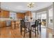 Well-lit kitchen with stainless steel appliances, center island, wooden cabinets, and access to backyard at 16680 Stroilway St, Hudson, CO 80642