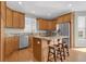 Well-appointed kitchen with wooden cabinets, granite countertops, stainless appliances, and a center island at 16680 Stroilway St, Hudson, CO 80642
