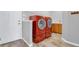 Laundry room with modern red appliances, a sink, and plenty of counter space at 16680 Stroilway St, Hudson, CO 80642
