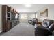 Comfortable living room features plush seating, a large entertainment center, and neutral decor for relaxation at 16680 Stroilway St, Hudson, CO 80642
