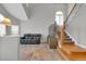 Open living room with high ceilings, slate floors, and staircase at 16680 Stroilway St, Hudson, CO 80642