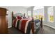 Bright bedroom with decorative wrought iron bed frame and bright views at 16680 Stroilway St, Hudson, CO 80642