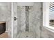 Modern shower features decorative tile, a glass door, and sleek fixtures in this beautifully designed bathroom at 16680 Stroilway St, Hudson, CO 80642