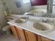 Bathroom featuring a double vanity with wood cabinets at 19939 Mitchell Cir, Denver, CO 80249