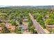 An elevated view captures the single-Gathering home and surrounding neighborhood, highlighting mature trees and well-maintained streets at 1830 Zang St, Golden, CO 80401