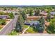 An aerial perspective displays the property, emphasizing its lush landscaping, solar panels, and desirable neighborhood location at 1830 Zang St, Golden, CO 80401