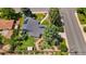 Aerial view of a beautiful home with a landscaped yard, solar panels, mature trees and well-maintained lawn at 1830 Zang St, Golden, CO 80401