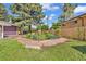 Spacious backyard with lush grass, a stone patio, and a well-maintained garden offers an inviting outdoor oasis at 1830 Zang St, Golden, CO 80401